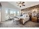 The spacious main bedroom includes a seating area with bay window and a wood-look accent wall at 4495 Windmill Dr, Brighton, CO 80601