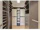 The custom designed walk-in closet features built-in shelving, drawers, and hanging rods for optimal storage at 4495 Windmill Dr, Brighton, CO 80601