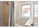 Bathroom featuring a shower, sink, and window at 910 Steele St, Denver, CO 80206