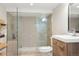 Modern bathroom showcasing a glass-enclosed shower and vanity with stylish fixtures at 910 Steele St, Denver, CO 80206
