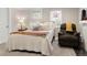 Comfortable bedroom with lots of pillows, natural light, and cozy seating area at 910 Steele St, Denver, CO 80206