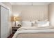 Bedroom has a comfortable bed, wood floors, and paneling at 910 Steele St, Denver, CO 80206