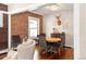 Inviting dining room with hardwood floors, brick accent wall, and stylish lighting at 910 Steele St, Denver, CO 80206