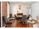 Dining room boasts hardwood floors, a round table, and modern decor at 910 Steele St, Denver, CO 80206