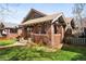 Quaint brick home with a well-manicured lawn, showcasing classic architectural charm and curb appeal at 910 Steele St, Denver, CO 80206