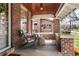 Cozy brick front porch with seating and outdoor rug at 910 Steele St, Denver, CO 80206