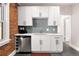 Modern kitchen featuring white cabinets, stainless steel appliances, and stylish backsplash at 910 Steele St, Denver, CO 80206