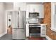 Bright kitchen featuring stainless steel appliances, light cabinets and modern lighting at 910 Steele St, Denver, CO 80206