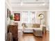Comfortable living room has hardwood floors, a white sofa, and vintage decorations at 910 Steele St, Denver, CO 80206
