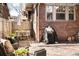 Charming brick patio with outdoor seating and grill, perfect for relaxing or entertaining guests in style at 910 Steele St, Denver, CO 80206