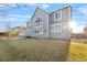 Backyard view with lawn and a view of the house's exterior at 13694 Cherry St, Thornton, CO 80602