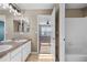 A bathroom with double sinks, a large mirror, and a shower/tub combo at 13694 Cherry St, Thornton, CO 80602