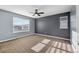 A large bedroom with carpeted floors and two windows for ample natural light at 13694 Cherry St, Thornton, CO 80602
