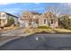 Charming two-story home with a stone facade and gray siding under a clear blue sky at 13694 Cherry St, Thornton, CO 80602