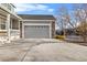 Attached two-car garage featuring stone accents and gray paint at 13694 Cherry St, Thornton, CO 80602