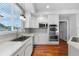 A modern kitchen features stainless appliances, white cabinetry, and lots of natural light at 13694 Cherry St, Thornton, CO 80602