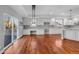 A sunlit kitchen with stainless appliances, granite countertops, and hardwood floors at 13694 Cherry St, Thornton, CO 80602