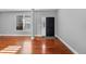 Bright living room with newly refinished hardwood floors, neutral paint and trim at 13694 Cherry St, Thornton, CO 80602