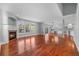 Bright living room with hardwood floors, fireplace and open layout to the kitchen at 13694 Cherry St, Thornton, CO 80602