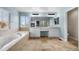 A luxurious bathroom with a soaking tub, dual vanities, and a fireplace view at 13694 Cherry St, Thornton, CO 80602