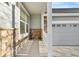 View of a porch featuring stone accents, white trim and railings at 13694 Cherry St, Thornton, CO 80602