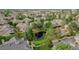 Aerial view of neighborhood featuring mature trees, lush landscaping, and a pond at 10087 E Hawaii Pl, Aurora, CO 80247