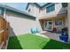 Fenced backyard featuring artificial turf and a patio at 10087 E Hawaii Pl, Aurora, CO 80247