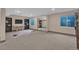 Finished basement with a neutral carpet and mirrored closet doors at 10087 E Hawaii Pl, Aurora, CO 80247