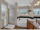 Bright bathroom with a soaking tub, shower, and dual sinks at 10087 E Hawaii Pl, Aurora, CO 80247