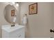 Neat half-bathroom featuring a vanity and decorative art at 10087 E Hawaii Pl, Aurora, CO 80247