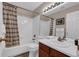 Bright bathroom with a shower-tub combination and a wood vanity at 10087 E Hawaii Pl, Aurora, CO 80247