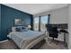 Bedroom featuring an accent wall, two windows and a workstation at 10087 E Hawaii Pl, Aurora, CO 80247