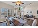 Bright dining room showcasing wood floors, a ceiling fan, vaulted ceilings, and large windows for natural light at 10087 E Hawaii Pl, Aurora, CO 80247