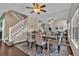 Elegant dining room with hardwood floors and a large mirror wall reflecting an open concept living space at 10087 E Hawaii Pl, Aurora, CO 80247