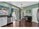 Cozy kitchen area leads to an exterior patio, complete with updated appliances and a wine rack at 10087 E Hawaii Pl, Aurora, CO 80247