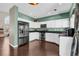 Modern kitchen features stainless steel appliances, granite countertops, and white cabinets, offering a stylish space at 10087 E Hawaii Pl, Aurora, CO 80247