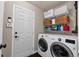 Functional laundry room with washer, dryer, and ample storage space at 10087 E Hawaii Pl, Aurora, CO 80247
