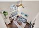 A bird's-eye view of the living room featuring high ceilings, a fireplace, and large windows for natural light at 10087 E Hawaii Pl, Aurora, CO 80247