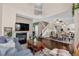 An open-concept living room with a fireplace and hardwood floors, seamlessly connected to the dining area at 10087 E Hawaii Pl, Aurora, CO 80247