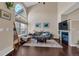 Bright and airy living room with a fireplace, large windows, and hardwood floors, creating a welcoming space at 10087 E Hawaii Pl, Aurora, CO 80247