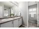 Bathroom with double vanity, updated fixtures, and a view into a shower at 9758 Laredo St # 37C, Commerce City, CO 80022