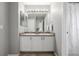 Well-lit bathroom featuring a double sink vanity, neutral walls, and a bright and airy feel at 9758 Laredo St # 37C, Commerce City, CO 80022
