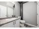 Bathroom with a white vanity, toilet, and grey walls, offering a clean and modern aesthetic at 9758 Laredo St # 37C, Commerce City, CO 80022