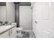 Bathroom featuring a white sink and vanity, gray walls, and neutral floor tiles at 9758 Laredo St # 37C, Commerce City, CO 80022