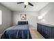 Cozy bedroom featuring a queen bed, dark blue furniture, and neutral walls with carpet at 9758 Laredo St # 37C, Commerce City, CO 80022