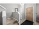 Inviting entryway with hardwood door, chandelier, and stairs, creating a warm and welcoming atmosphere at 9758 Laredo St # 37C, Commerce City, CO 80022