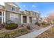 Street view featuring multiple townhomes with stone accents, siding, and well-kept landscaping, creating a desirable community aesthetic at 9758 Laredo St # 37C, Commerce City, CO 80022