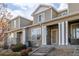 Well-maintained exterior of townhomes featuring stone accents and covered front porches at 9758 Laredo St # 37C, Commerce City, CO 80022