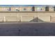 Multiple beige attached garages, enhanced with stone accents, for convenient parking and storage at 9758 Laredo St # 37C, Commerce City, CO 80022