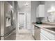 Modern kitchen with stainless steel refrigerator and view to hallway and bathroom at 9758 Laredo St # 37C, Commerce City, CO 80022